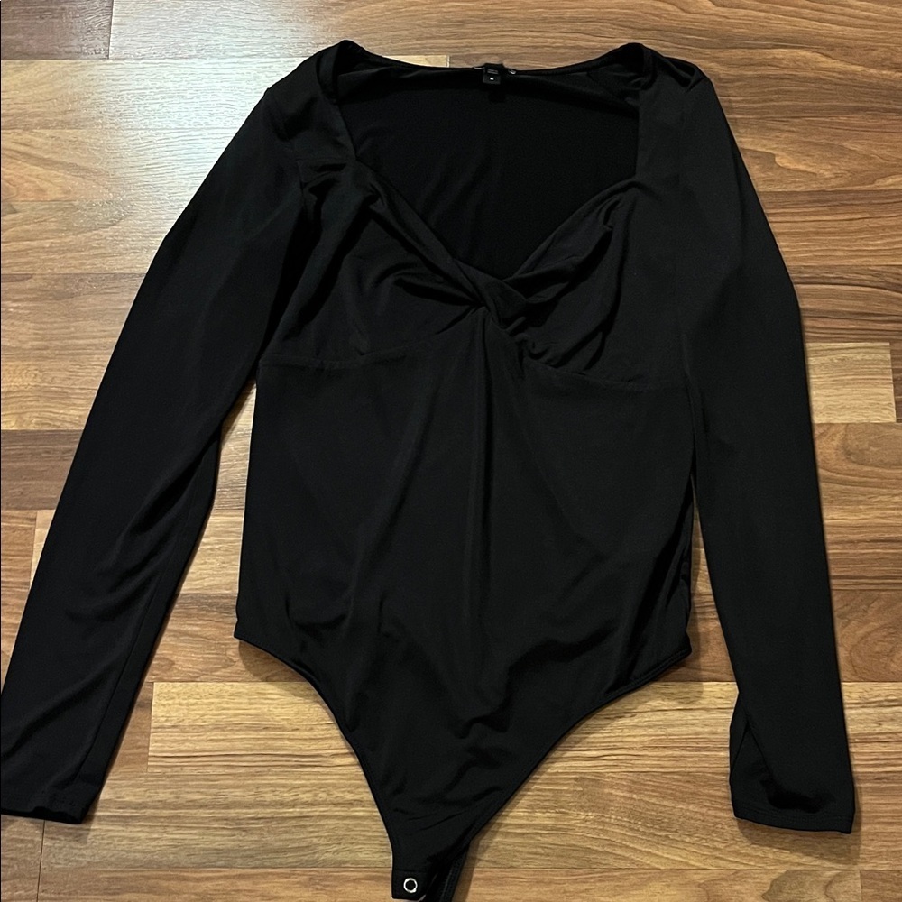 Express twist front long sleeved thong bodysuit.